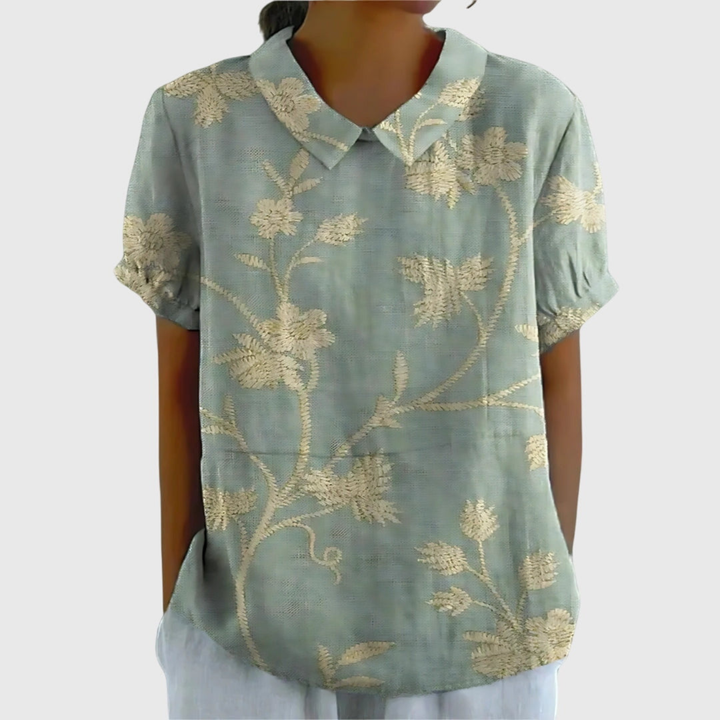 Back view of women's floral print collared blouse, showing relaxed fit and short sleeves.
