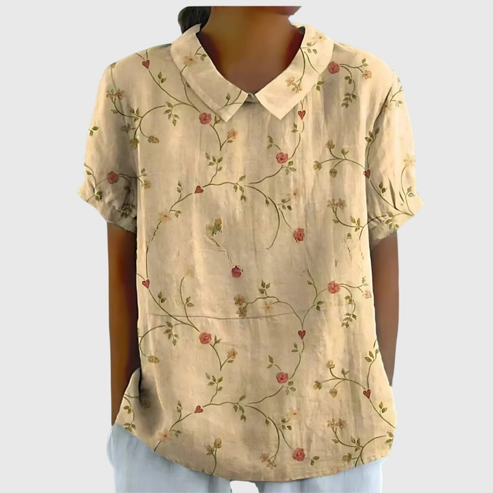 Vibrant floral print women's collared blouse, short-sleeved, offering a fresh look for summer.