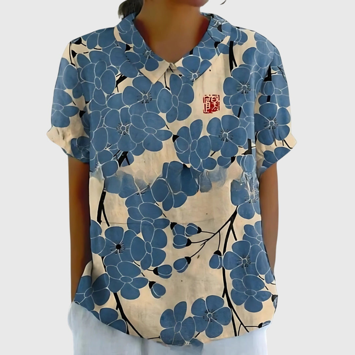 Women's floral print short-sleeve collared blouse, embodying effortless style for sunny days and casual events.