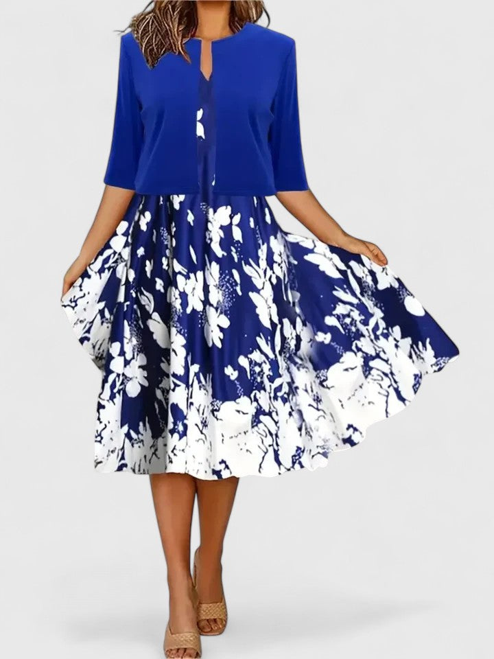 Women's elegant A-line midi dress. Features floral print, modern colorblock panels & a flattering notch neck.