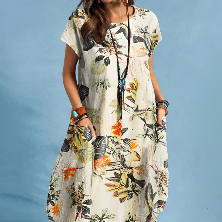 Comfortable women's midi dress featuring a vibrant floral print, short sleeves, and convenient side pockets.
