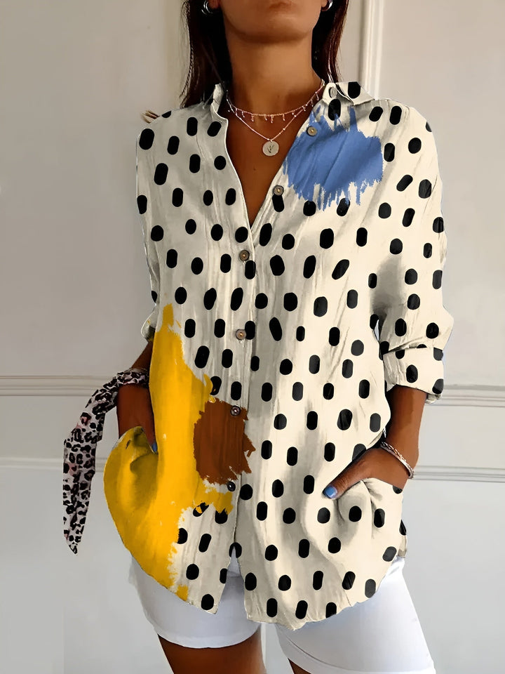 Women's floral print oversized button-down blouse. Relaxed fit, long sleeve printed top for warm weather style.