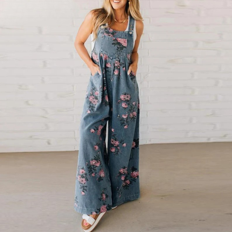 Women's floral print wide leg dungaree jumpsuit. Boho casual summer fashion with a relaxed fit and vibrant pattern.
