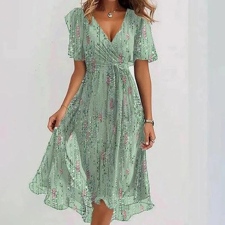 Feminine V-neck wrap midi dress with delicate flutter sleeves and a stylish ruffle hem. Perfect for vacation.