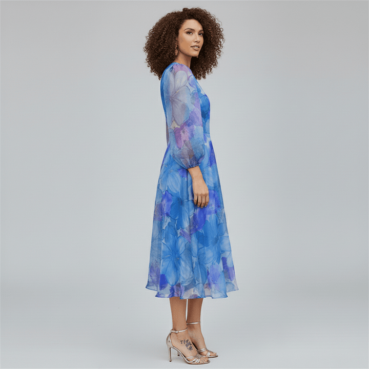 Women's floral puff sleeve A-line midi dress. Beautiful summer occasion wear for wedding guests & special events.