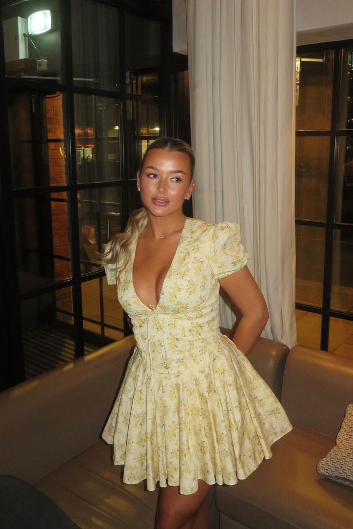 Sunny yellow floral puff sleeve mini dress, perfect summer outfit with an open back.