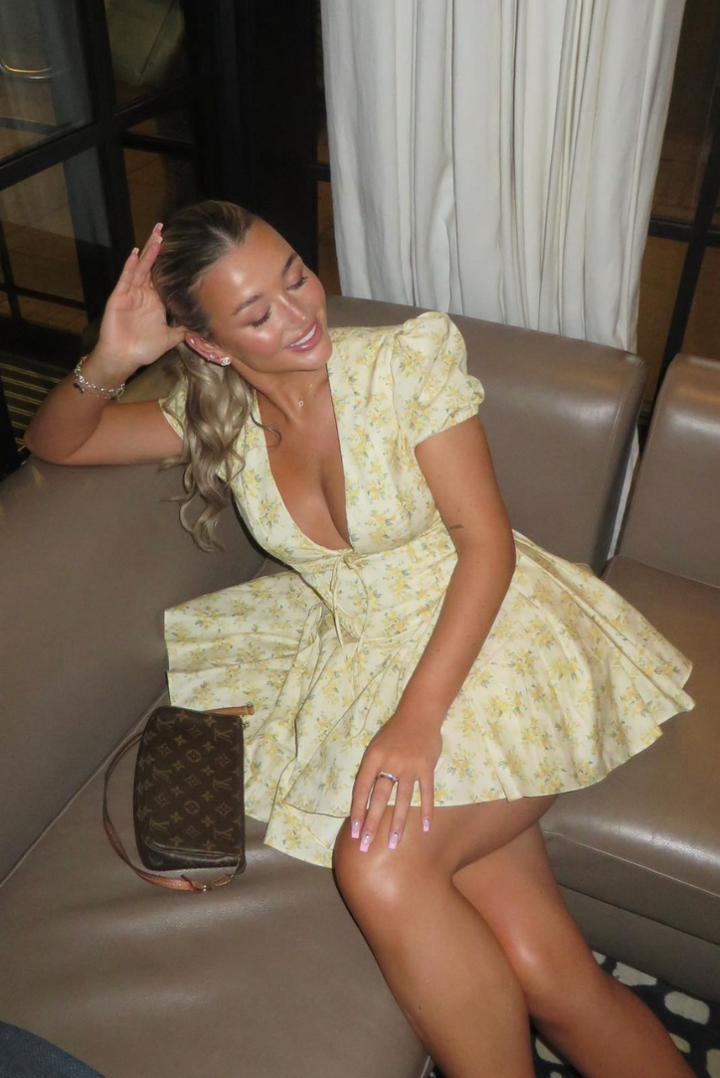 Breezy floral puff sleeve mini dress with an elegant open back, perfect for summer.