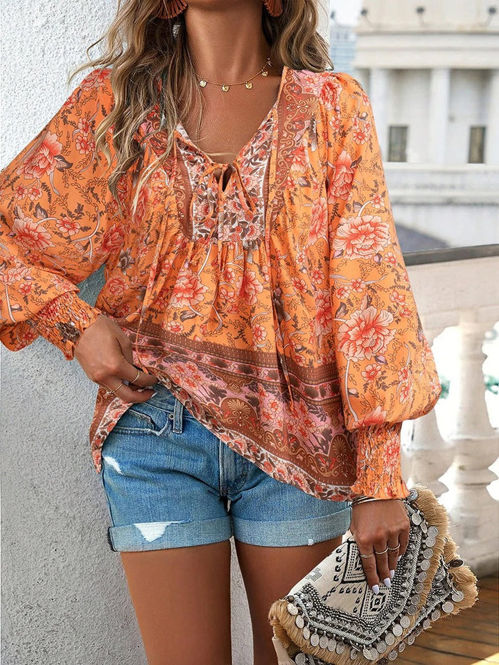 Versatile women's floral puff sleeve blouse, ideal for summer casual & feminine looks.