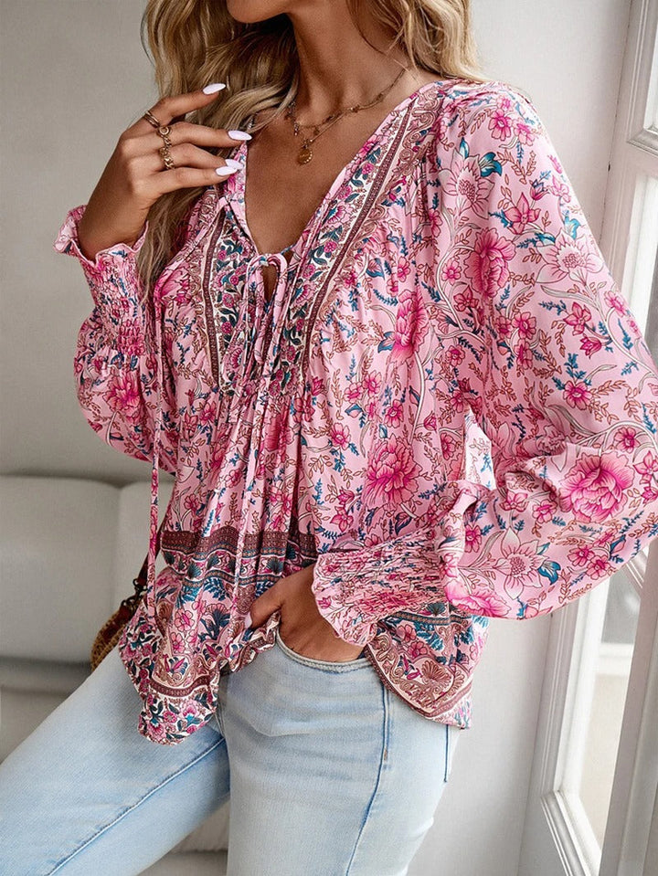 Lightweight women's puff sleeve floral blouse, a stylish and feminine summer apparel choice.