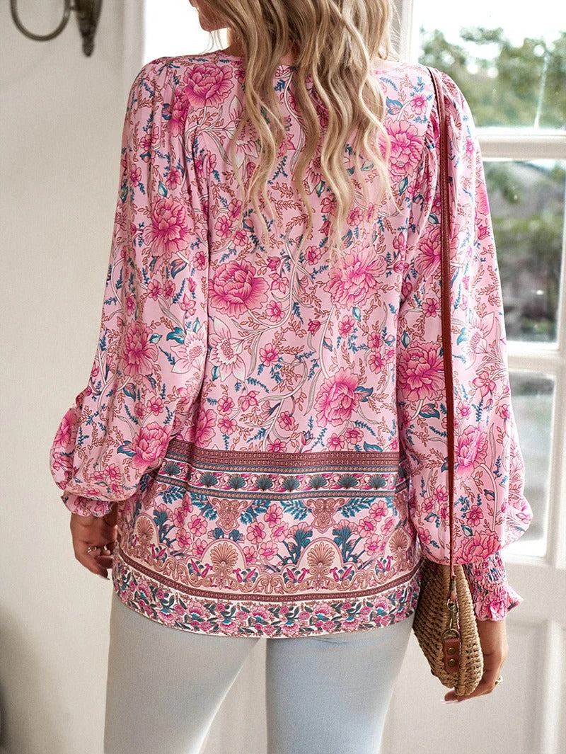 Vibrant floral print women's top with elegant puff sleeves, perfect for summer style.