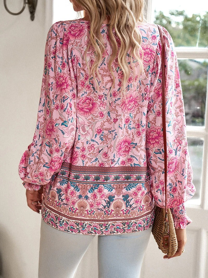 Vibrant floral print women's top with elegant puff sleeves, perfect for summer style.