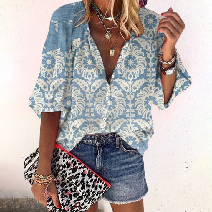 Vibrant floral print V-neck women's blouse with short sleeves and a chic button-front design.
