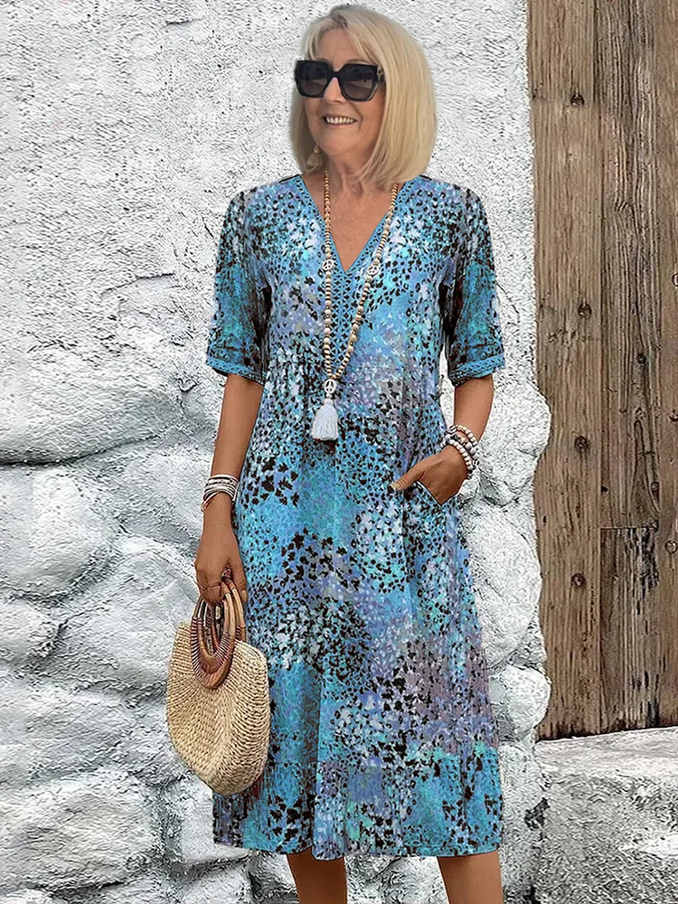 Stylish women's V-neck midi dress featuring a vibrant floral print, great for summer fashion.