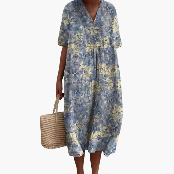 Beautiful women's floral midi dress, V-neck, short sleeves, comfortable oversized design, ideal for travel.