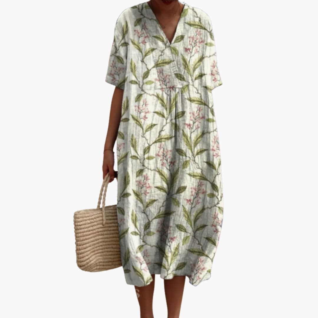 Full-length view of a women's floral oversized V-neck midi dress with handy side pockets.