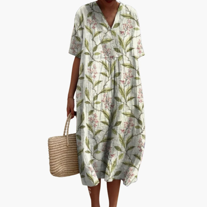 Full-length view of a women's floral oversized V-neck midi dress with handy side pockets.