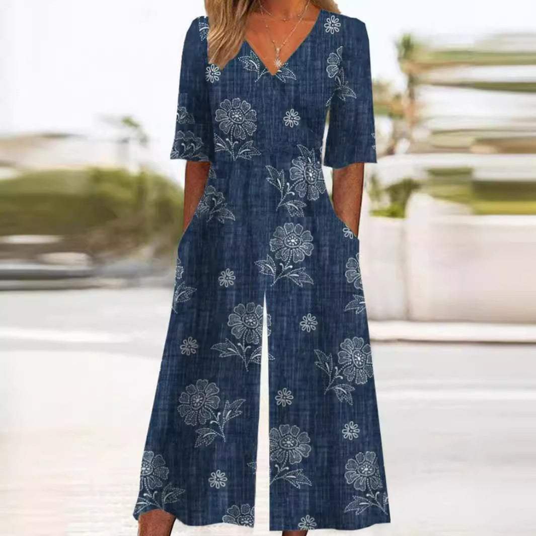 Chic black floral V-neck wide-leg jumpsuit with elbow sleeves. Women's casual palazzo style for summer fashion.
