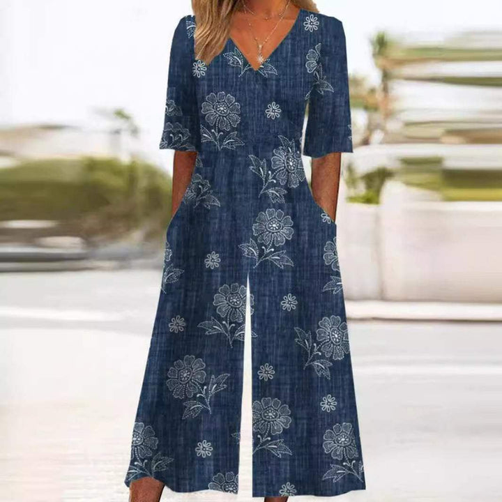 Chic black floral V-neck wide-leg jumpsuit with elbow sleeves. Women's casual palazzo style for summer fashion.
