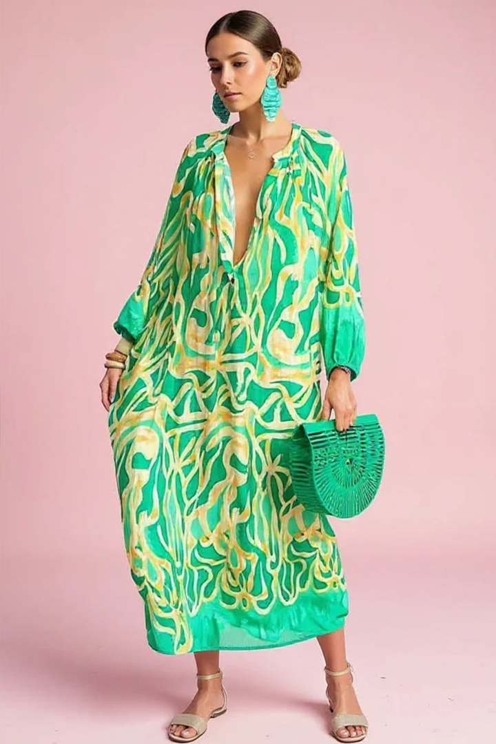 Women's flowing abstract print V-neck kaftan maxi dress. Perfect for resort wear or a stylish summer outfit.