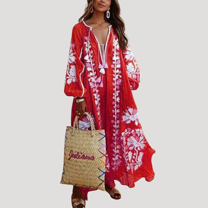 Women's flowing boho maxi dress with V-neck, long sleeves, & vibrant bohemian pattern, perfect for summer casual style.