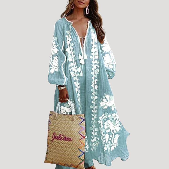 Casual patterned maxi dress for women, ideal for spring/summer. Features a V-neck, long sleeves, & flowing bohemian style.