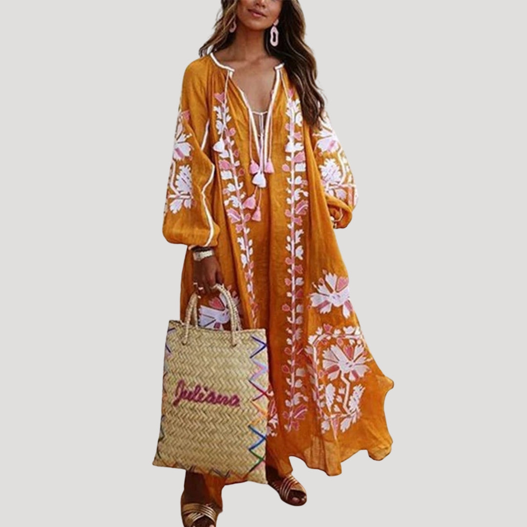 Comfortable women's boho maxi dress with a relaxed fit, long sleeves, V-neck, & artistic pattern, perfect for daily wear.