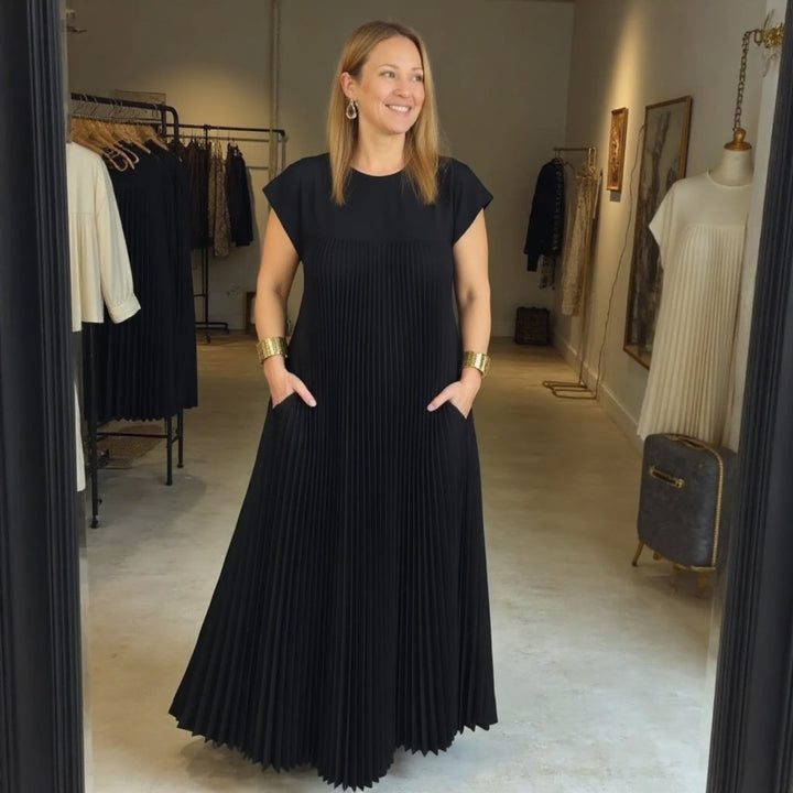 Classic women's flowing maxi dress with elegant pleats. Versatile, comfortable & chic for any event.