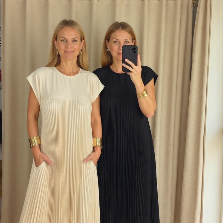 Graceful women's long pleated maxi dress. Flowing fabric ensures comfort, pleats add elegant style.
