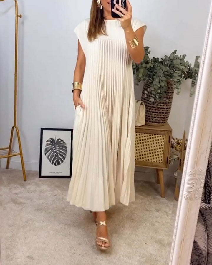Feminine flowing pleated maxi dress for women. Elegant design, comfortable fit, versatile for day or night.