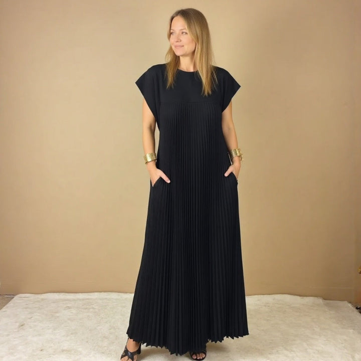 Women's chic pleated maxi dress with beautiful flow. Versatile, comfortable, & elegant for any event.