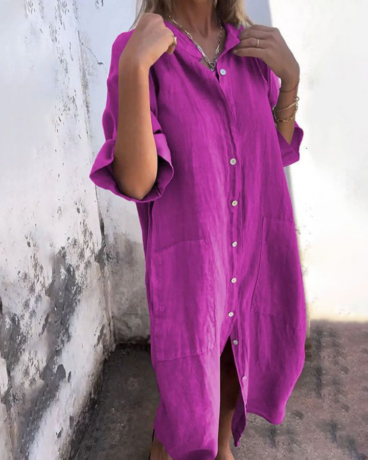 Woman wearing a stylish flowy boho midi shirt dress with button-front & adjustable waist, ideal for summer.