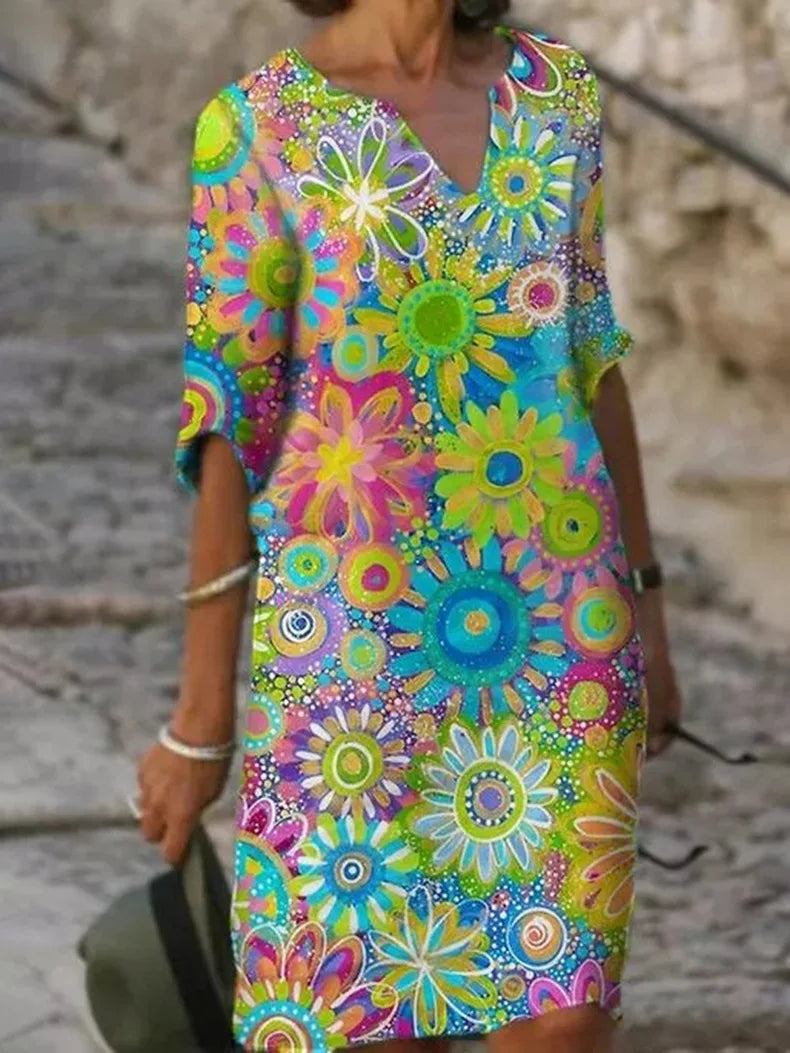 Chic women's sleeveless midi dress featuring vibrant floral print & flowy design. Ideal for summer casual elegance or vacation.