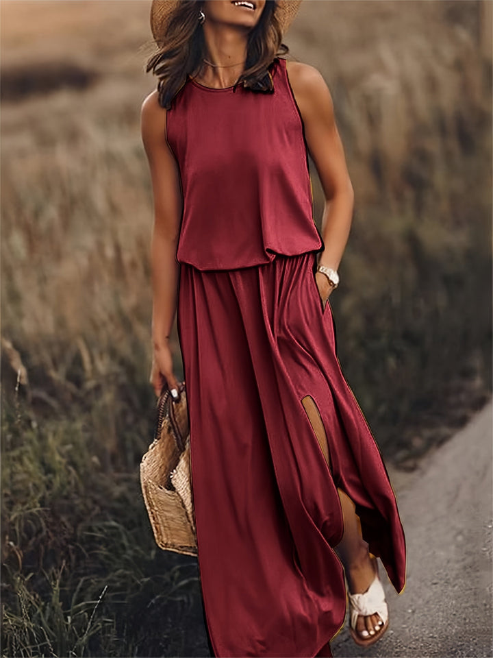Sleeveless women's flowy maxi dress, featuring a flattering side slit and essential pockets. Perfect for summer.