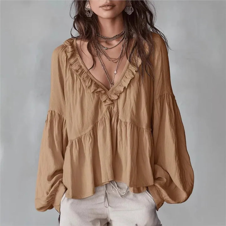 Women's flowy ruffle blouse with V-neck, long puff sleeves. Elegant and chic spring/summer top.