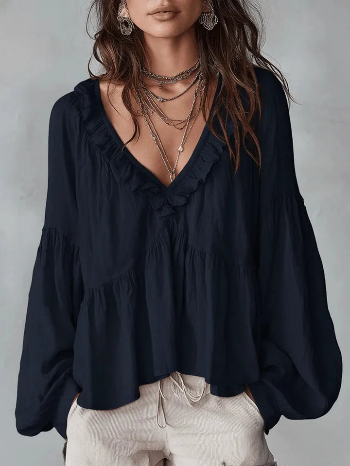 Chic women's flowy blouse featuring elegant ruffles and V-neck. Versatile long sleeve top.