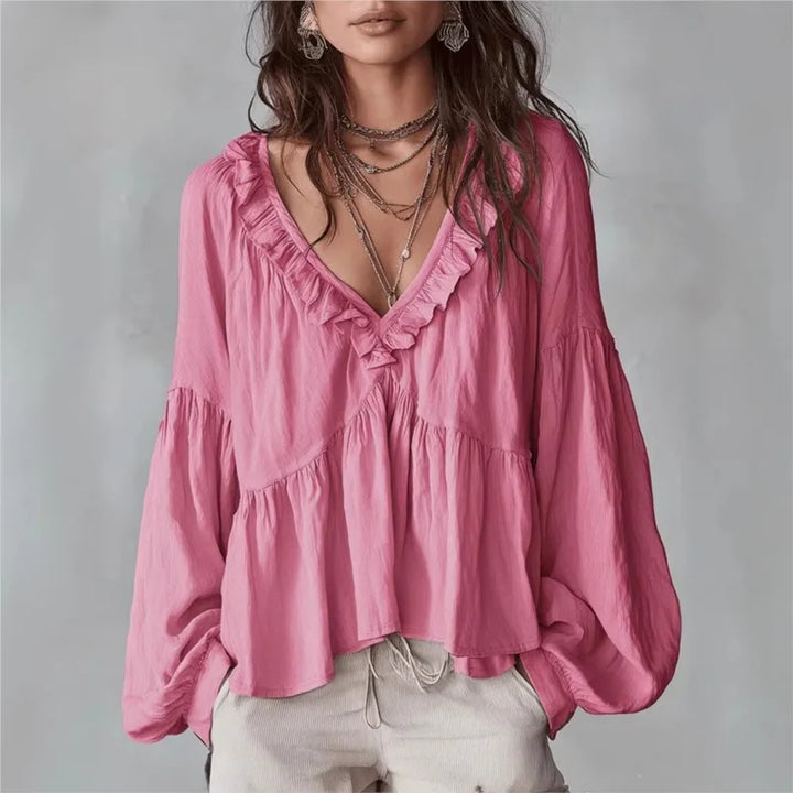 Elegant women's puff sleeve blouse with flowy fabric and stylish ruffle details. Ideal for spring.