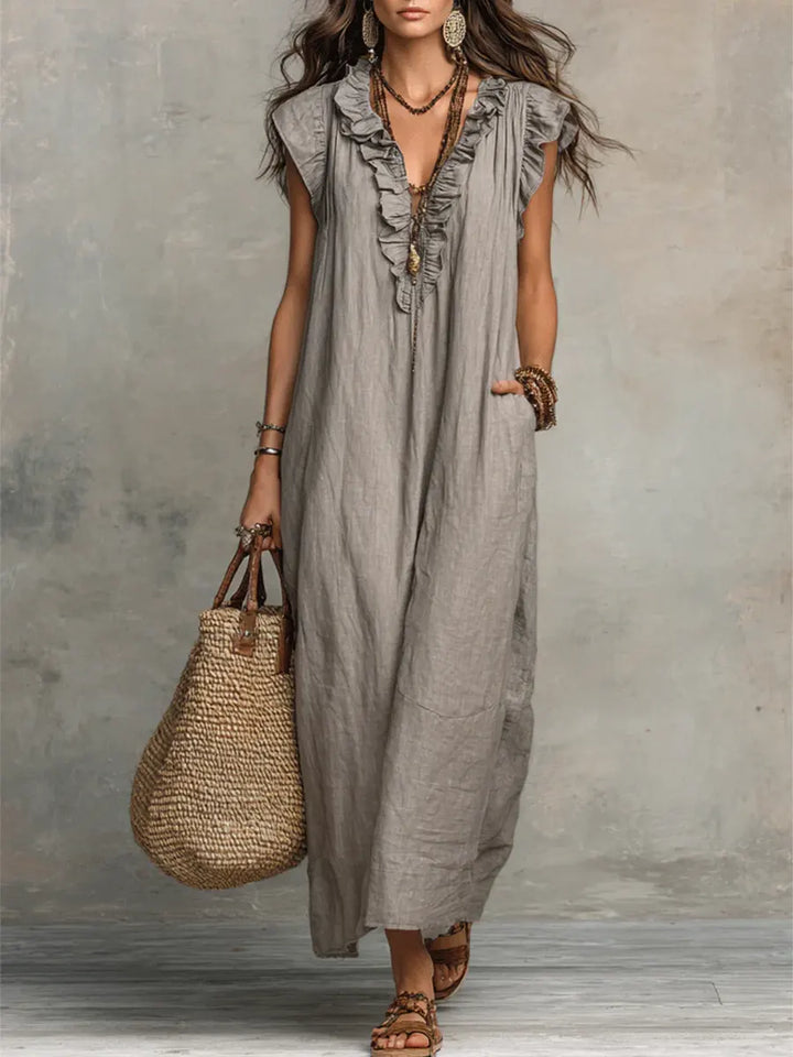Women's flowy ruffle V-neck maxi dress with elegant flutter sleeves, perfect for summer.