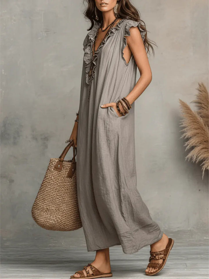 Chic women's flowy maxi dress with V-neck, ruffles, flutter sleeves, and convenient side pockets.