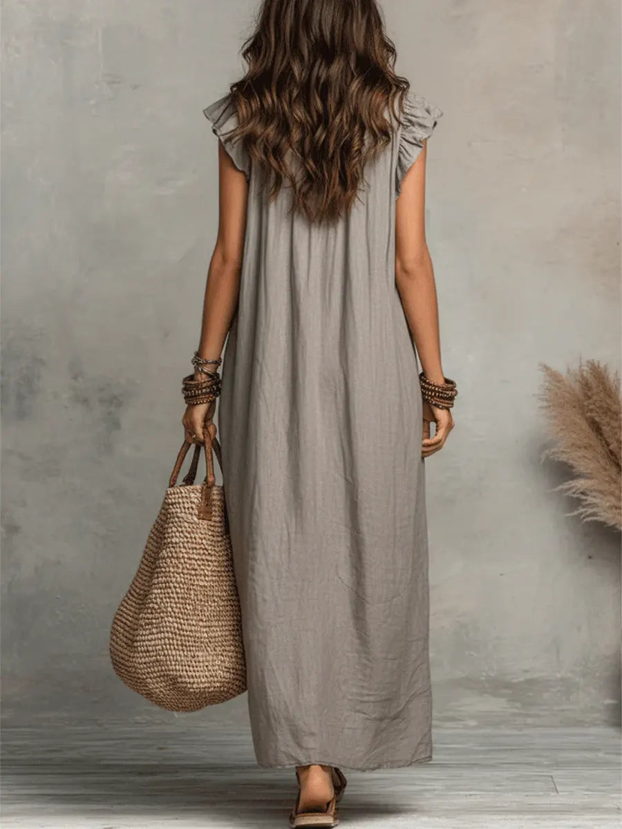 Lightweight women's flowy maxi dress, V-neck, flutter sleeves, ideal for warm weather or vacations.