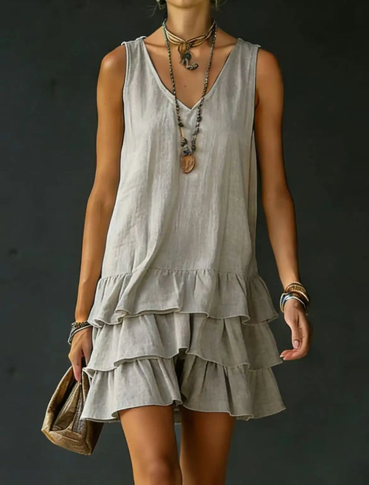 Elegant women's sleeveless tiered ruffle mini dress, featuring a flattering V-neck, perfect for summer vacation.