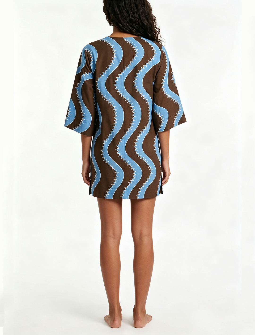 Effortless women's shift mini dress featuring a vibrant wave print, collared button front, great for vacation style.