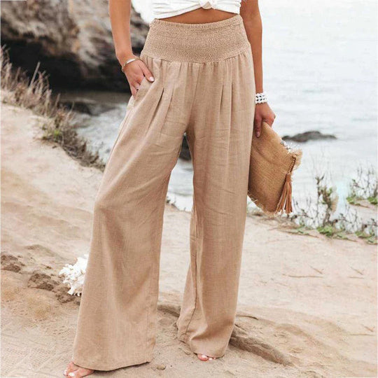 Model in women's flowy wide leg summer pants, showcasing relaxed fit and comfortable elastic waist.