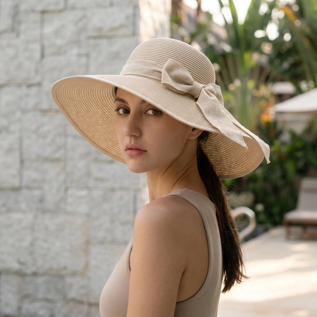 Women's foldable wide brim sun hat for travel, offering stylish UV protection on the beach or vacation.