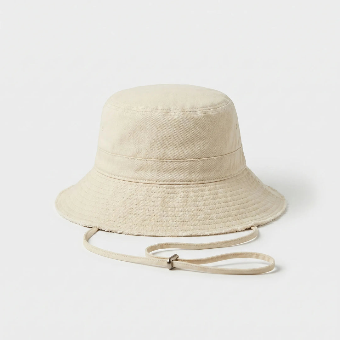 Casual women's summer bucket hat with frayed brim, perfect for beach, travel & sun protection.