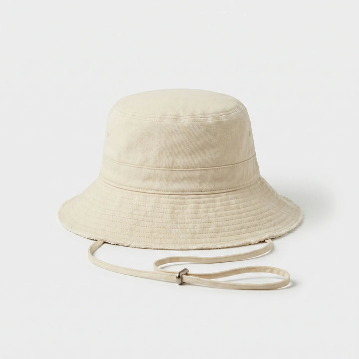 Casual women's summer bucket hat with frayed brim, perfect for beach, travel & sun protection.