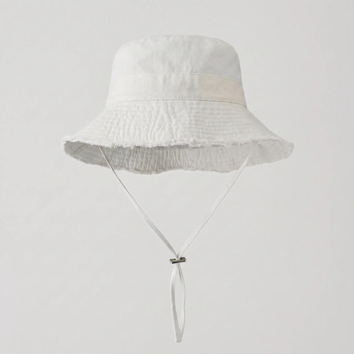 Ladies' solid color bucket hat, frayed brim, ideal for beachwear, travel, and sun protection.