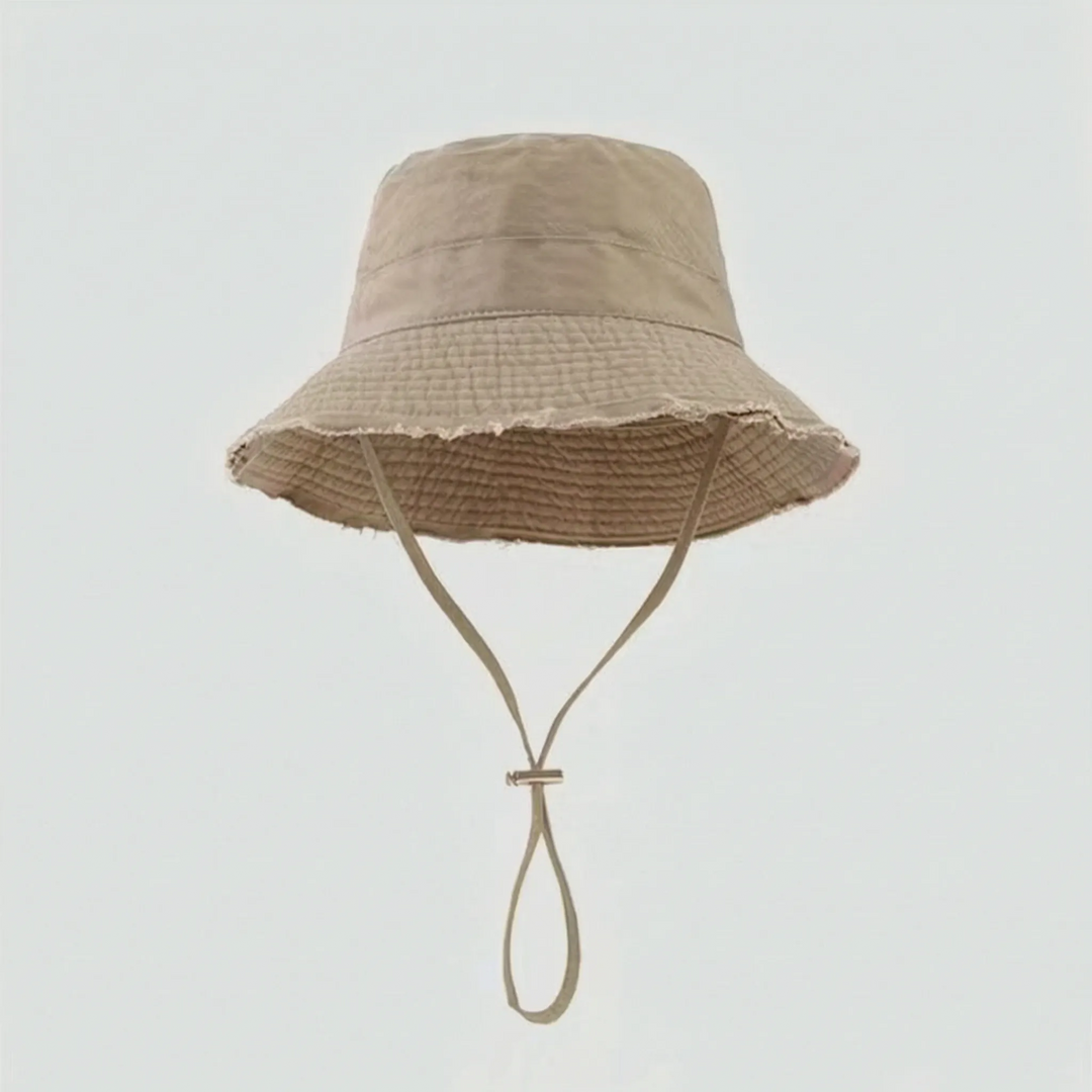 Beach ready women's bucket hat, frayed brim, adjustable fit for ultimate sun protection on travels.