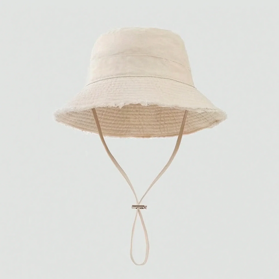 Stylish women's headwear: frayed brim bucket hat, adjustable for summer sun protection & travel.