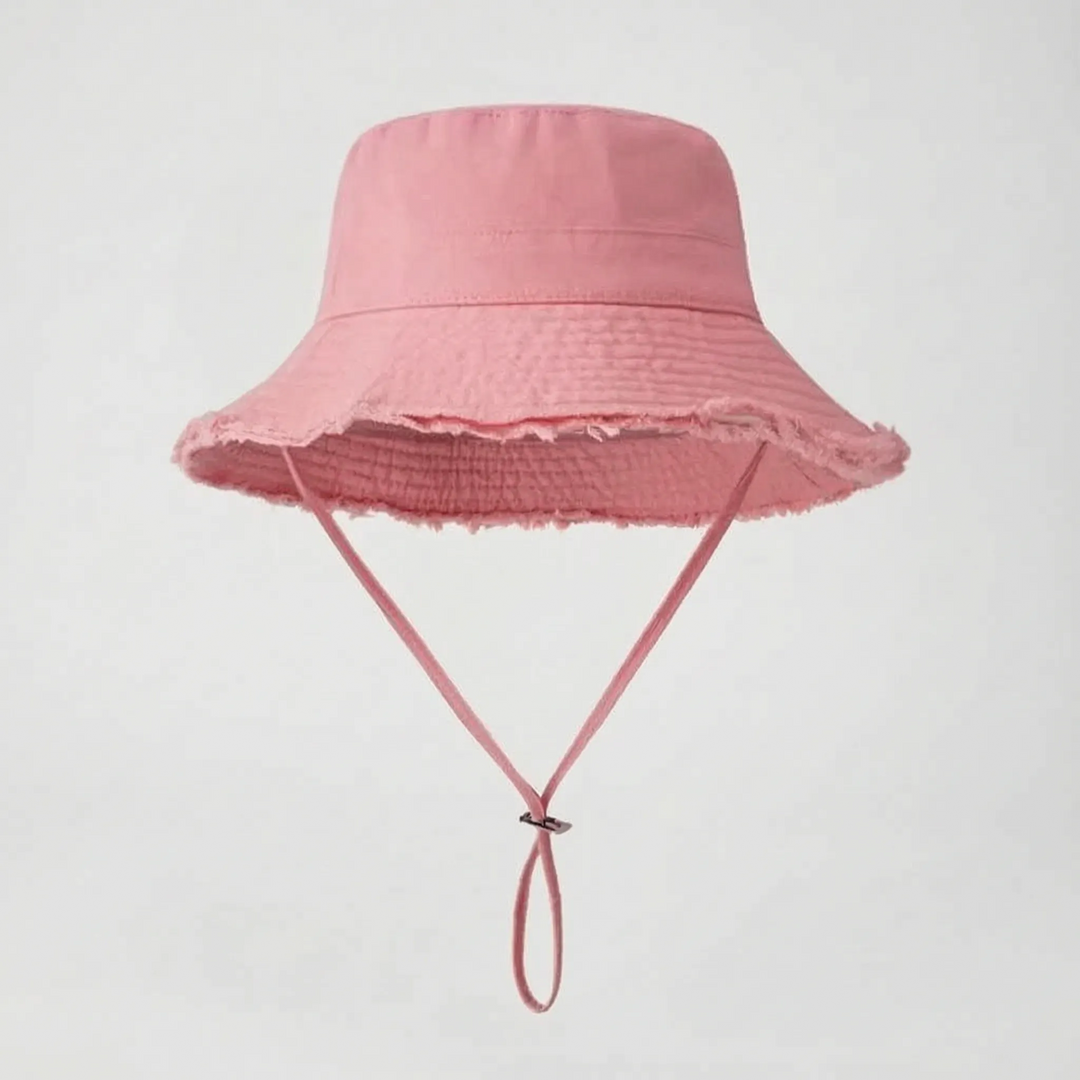 Solid color women's bucket hat with chic frayed brim. Adjustable, perfect for summer sun protection.