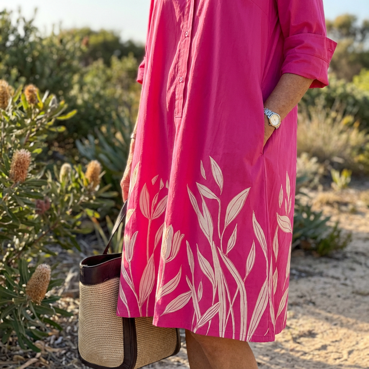 Elegant women's luxe fuchsia floral midi dress. Sophisticated button-down, a versatile summer or occasion wear garment.